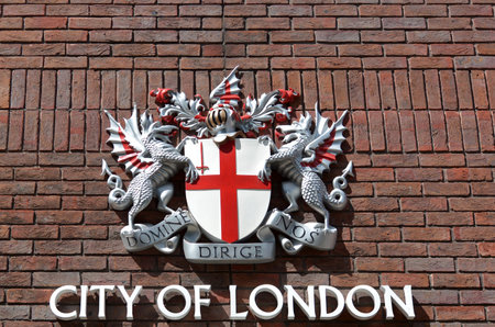 LONDON - MAY 12 2015:City of London Sign on brick wall .The City has a unique political status of integrity as a corporate city since the Anglo-Saxon period and its singular relationship with the Crown.のeditorial素材