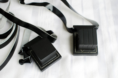 A set of tefillin includes the arm-tefillin (left)and the head-tefillin on Talit.の写真素材
