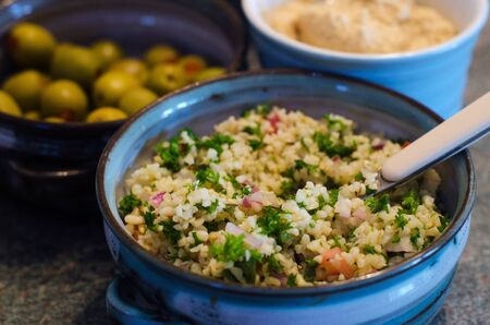 Classic Tabbouleh salad. It's a Levantine Arab salad traditionally made of bulgur, tomatoes, finely chopped parsley, mint, onion and garlic, and seasoned with olive oil, lemon juice and salt.の写真素材
