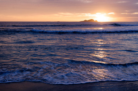 NORTHLAND - JAN 20:Sunrise over Henderson bay on January 20 2013 in Northland NZ. It's  a unique isolated and wild sandy beach with special wildlife, vegetation, sand dunes and rock formations on the Aupouri Peninsula, at the very top of the North Island のeditorial素材