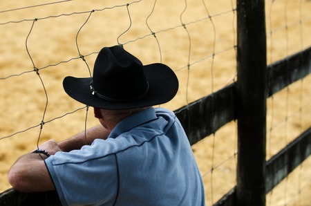 Cowboy watching rodeo show.の写真素材