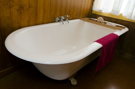 An old vintage bath in a home bathroom.の写真素材
