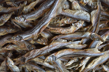 Dried small anchovies fish at the market in Chinatown. Food background texture.