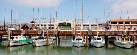 Panoramic view of a line of fishing boats in Fisherman Wharf, San Francisco CA.のeditorial素材