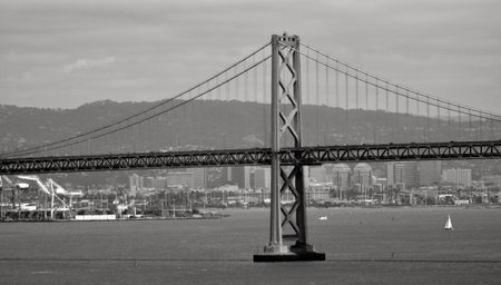 SAN FRANCISCO - MAY 17 2015:Ferry sail under Oakland Bay Bridge San Francisco, California.It carries about 240,000 vehicles a day on its two decks.It has one of the longest spans in the United States.のeditorial素材