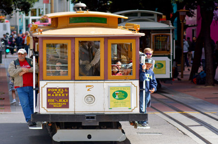 SAN FRANCISCO - MAY 16 2015:Passengers riding on Powell-Hyde line cable car in San Francisco, CA.San Franciscoâs Cable Cars (and Streetcars!) are Iconic Movie Setpieces such as Dirty Harry (1971).のeditorial素材