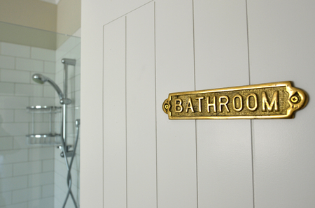 Bathroom sign on a home bathroom door of a shower room.の写真素材