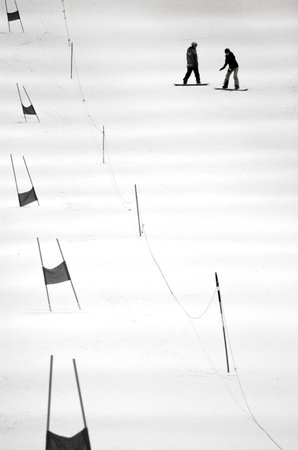 AUCKLAND - JULY 31 2015:Two people sliding on snowboard in Snowplanet.It's New Zealand's first indoor snow facility features 50cm of real snow of a terrain park for freestyle skiers and snowboarders.のeditorial素材