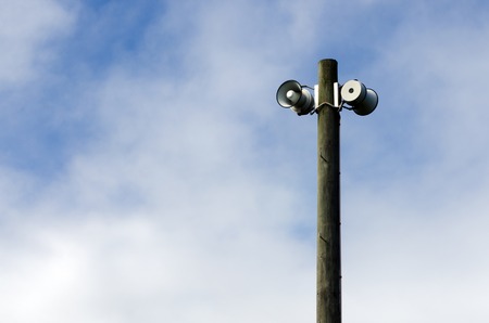 Air raid siren against blue sky.の写真素材