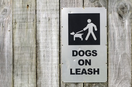 Warning street sigh of a dog on leash.の写真素材