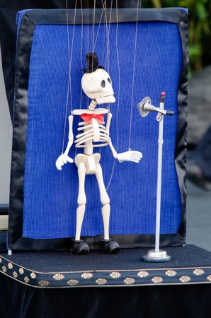 Skeleton puppeteer singing in the street.の写真素材