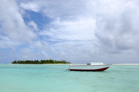 Small fishing boat in Aitutaki lagoon Cook Islands.の写真素材