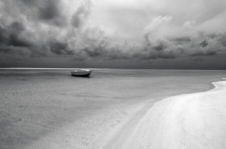 Small fishing boat in Aitutaki lagoon Cook Islands. (BW)の写真素材