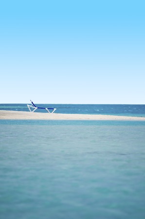 Empty beach chairs on sandbank in Arutanga island in Aitutaki Lagoon Cook Islands.の写真素材