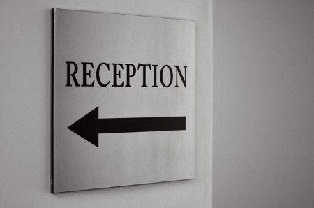 Reception sign with direction arrow. (BW)