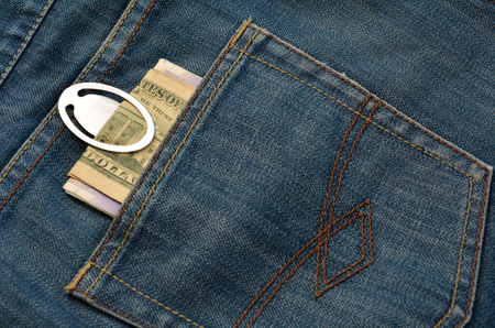 Money bank notes fasten with money clip in the back pocket of jeans.Money Concept.の写真素材