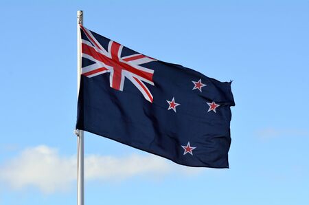 The National flag of New Zealand against blue sky.の写真素材
