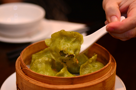 Chines food, Dim sum served in wooden bamboo basket.の写真素材