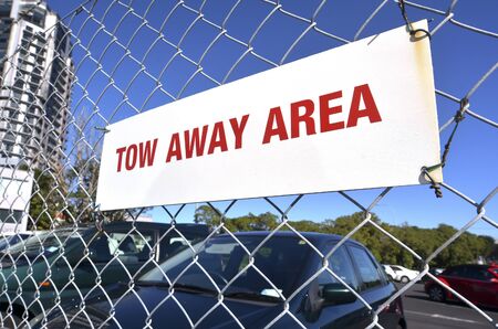 Tow away area sign in a parking lot.の写真素材