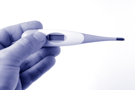 Man hand holds Thermometer on white background. Concept photo of medical, health care, healthy,...