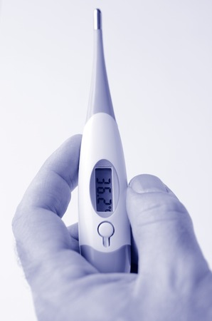 Man hand holds Thermometer on white background. Concept photo of medical, health care, healthy, lifestyle. (BW)の写真素材