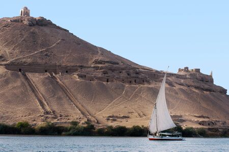 A Felucca sails on the Nile river near Aswan, Egypt.の写真素材