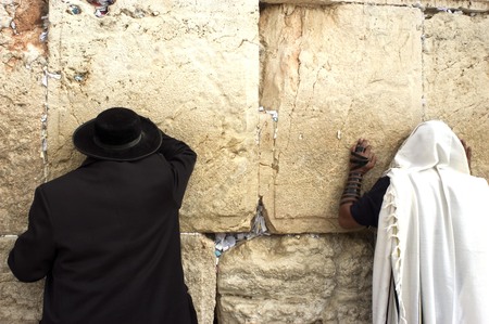 Jewish orthodox men pray at the western wall in the old city of Jerusalem, Israelの写真素材