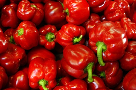 Red capsicums on display in the market.
