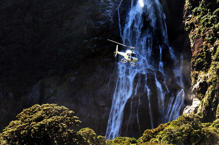 A helicopter flies over Fiordland, southern New Zealand.の写真素材