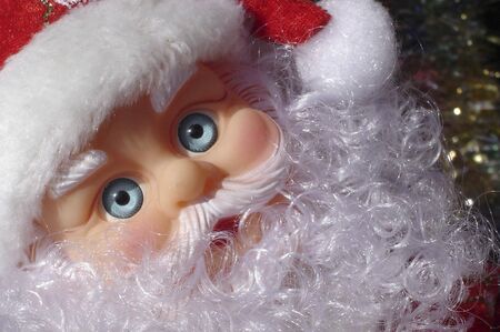 Christmas decoration objects for sale in a shop including lights and a santa doll.