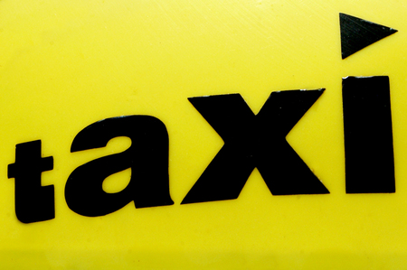 Yellow taxi cab sign.の写真素材