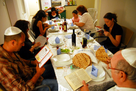 JERUSALEM - APRIL 20: Jewish family are reading the traditional Hagaddah seder ritual on the Jewish holiday of Passover on April 20 2008 in Jerusalem, Israel.のeditorial素材