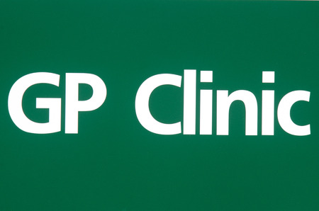 GP clinic sign on green background.の写真素材