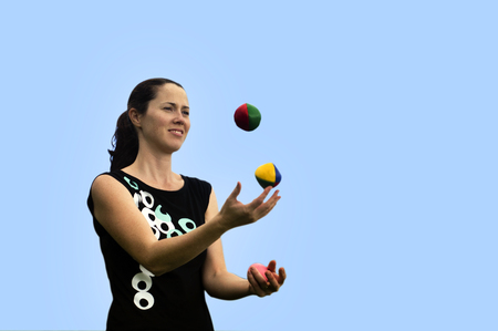 Young woman juggler is juggling balls.の写真素材