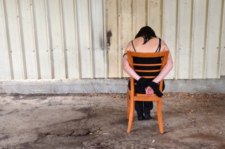 Image of a woman horrified from criminal hands holding dangerous knifeの写真素材