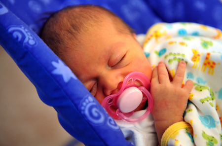 A newborn baby feeding and sleep in peace.