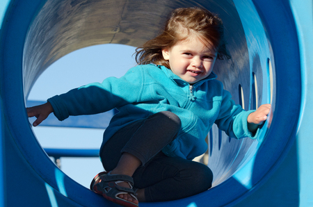 Little girl plays in playground.の写真素材