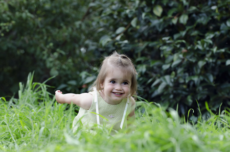 An adorable girl plays and smiles during a summer vacation.の写真素材