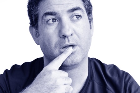 Mature man thinking with one finger on his lips looking away.close up on white background. real people. Concept photo of puzzled, confused, worried, problems, alone, thoughtful, worried, man (BW)の写真素材