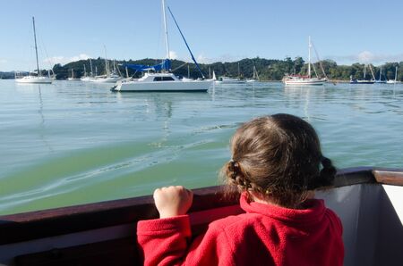 Little girl sailing on a yacht at sea.の写真素材