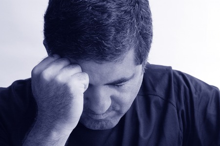 Man with headache holding his hand against the head isloated against white background with copy space. Real people concept photo of man stress, headache , depression, depressed, unhappy. (BW)の写真素材