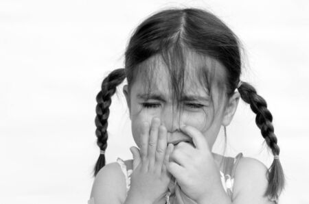 Little girl (age 4) cry,  isolated on white background. concept photo of child care, childhood, education, emotion, behavior,psychology.(BW)の写真素材