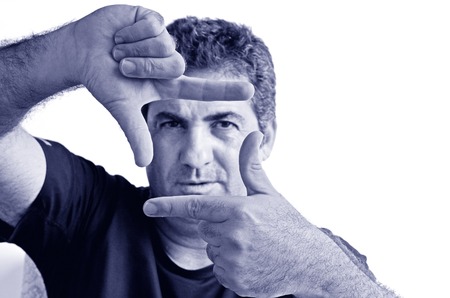 Serious one young mature man only creating frame with fingers.Copy space on white background. real people. Concept photo of cool, creative, confident, aspirations, manly, man. (BW)の写真素材