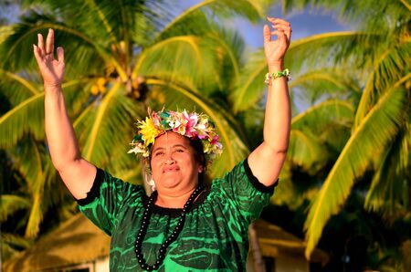Portrait of happy smily mature Polynesian Pacific Islander woman on tropical beach with palm trees in the background.の写真素材