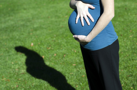 Pregnant woman relaxing in outdoor in the park during pregnancy. Concept photo of women healthy life...