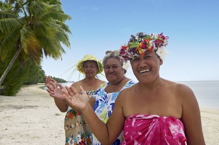 Portrait of Polynesian Pacific Island Tahitian mature females smiles and wave haloha, hellow,  on the beach in Aitutaki lagoon Cook Islands.の写真素材