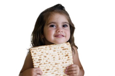 Jewish girl eating a matzo in passover Jewsih holiday.の写真素材