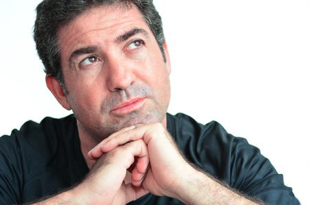 Mature man day dreaming.close up on white background. real people. Concept photo of puzzled, confused, worried, problems, alone, thoughtful, worried, manの写真素材