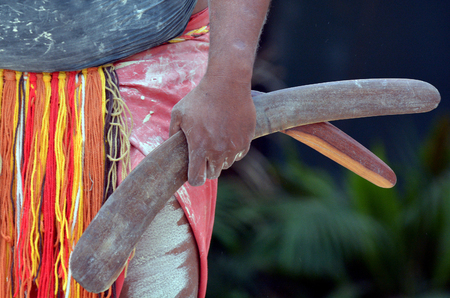 Yugambeh Aboriginal man hand holds boomerangs during Aboriginal culture show in Queensland, Australia.の写真素材