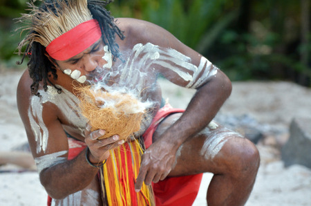 Portrait of one Yugambeh Aboriginal warrior demonstrate  fire making craft during Aboriginal culture...